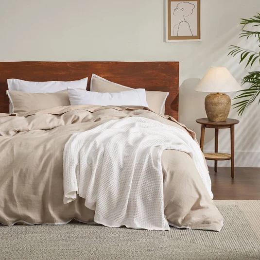 Protective bedding cover fitted neatly to a bed